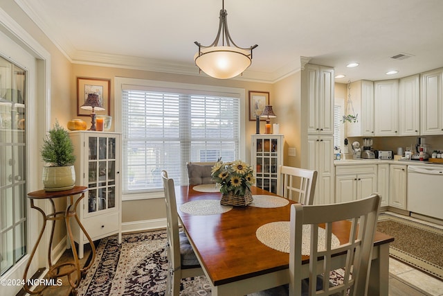 dining space featuring crown molding