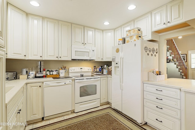 kitchen featuring white appliances and white cabinetry