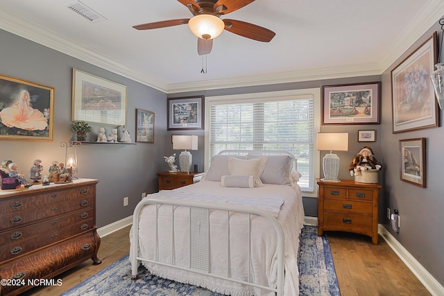 bedroom featuring crown molding, ceiling fan, and light hardwood / wood-style floors