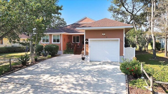 view of front of house featuring a front lawn and a garage