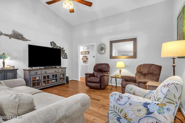 living room featuring high vaulted ceiling, wood-type flooring, and ceiling fan