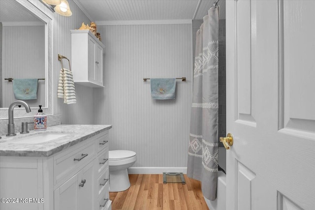 bathroom with vanity, ornamental molding, wood-type flooring, and toilet