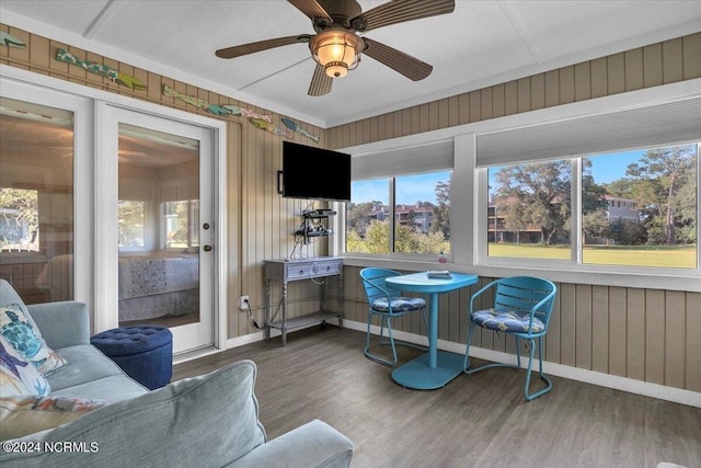 sunroom / solarium featuring ceiling fan