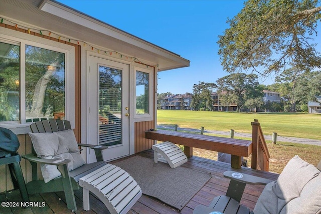 wooden terrace featuring a yard