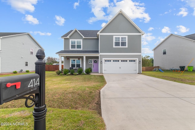 view of front of property featuring a front yard and a garage