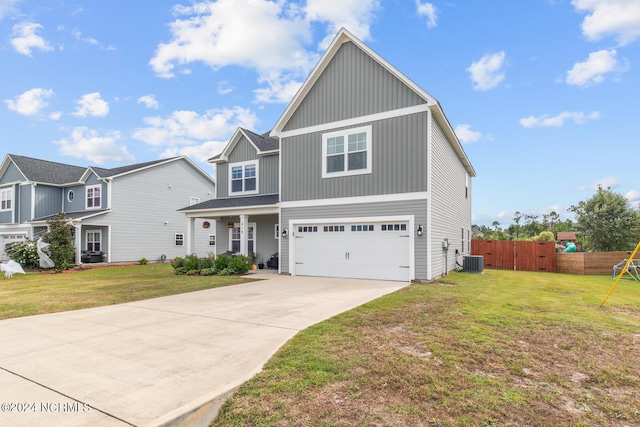 view of front of home featuring central AC unit, a garage, and a front lawn