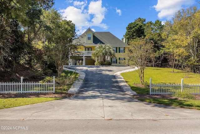 craftsman inspired home with a garage and a front lawn