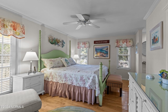 bedroom with ornamental molding, light wood-type flooring, and ceiling fan