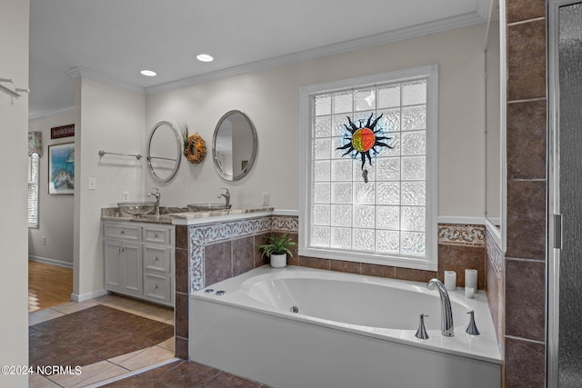 bathroom featuring a bathtub, crown molding, a wealth of natural light, and vanity