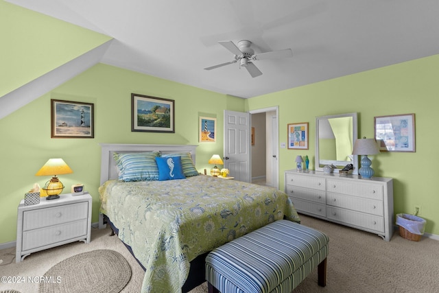 carpeted bedroom with vaulted ceiling and ceiling fan