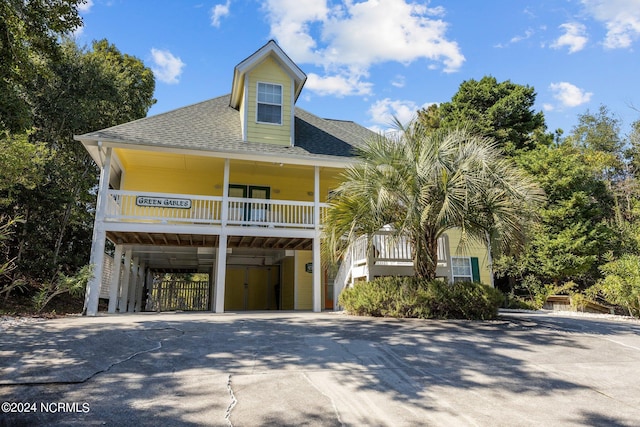 view of front of house with a carport and covered porch