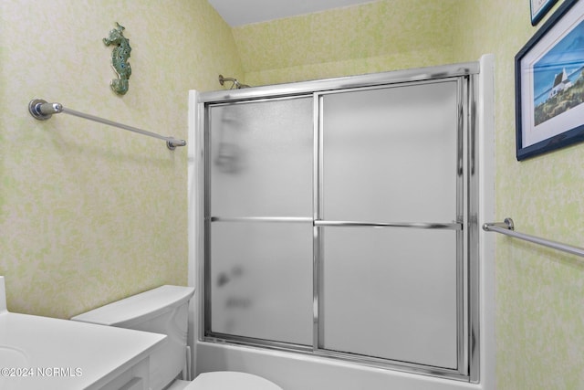 full bathroom featuring shower / bath combination with glass door, vanity, and toilet