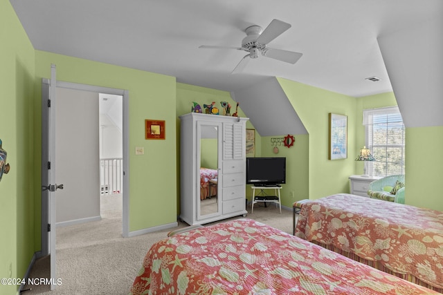 bedroom with ceiling fan, light carpet, and vaulted ceiling