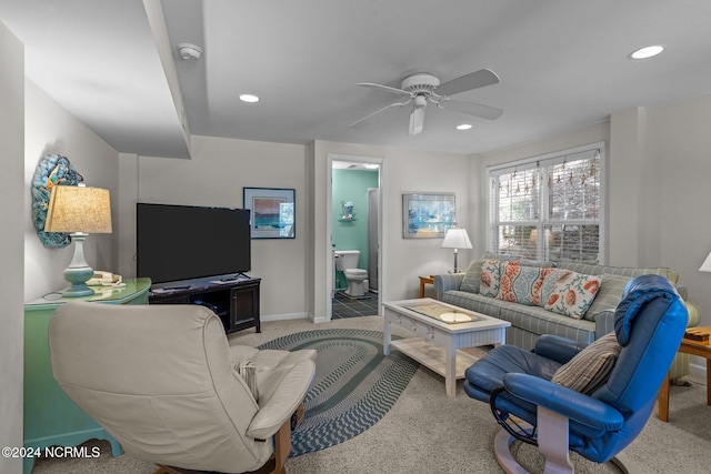 carpeted living room featuring ceiling fan