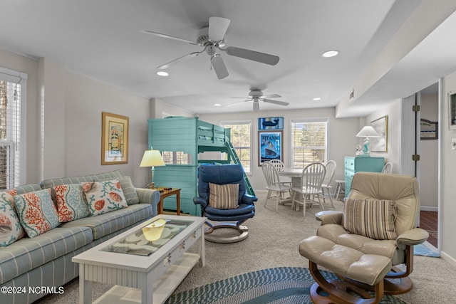 living room featuring plenty of natural light, carpet, and ceiling fan