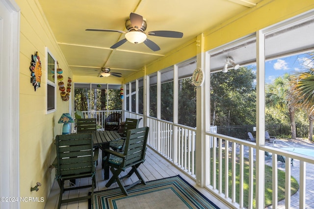 sunroom featuring ceiling fan and a healthy amount of sunlight