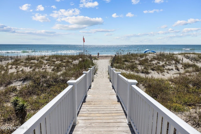 view of property's community with a beach view and a water view