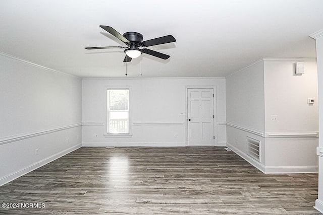 unfurnished room with dark wood-type flooring, ornamental molding, and ceiling fan