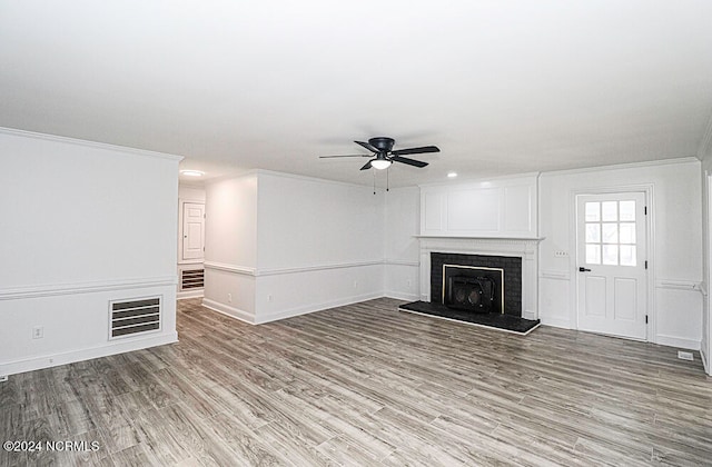 unfurnished living room featuring ornamental molding, light wood-type flooring, and ceiling fan