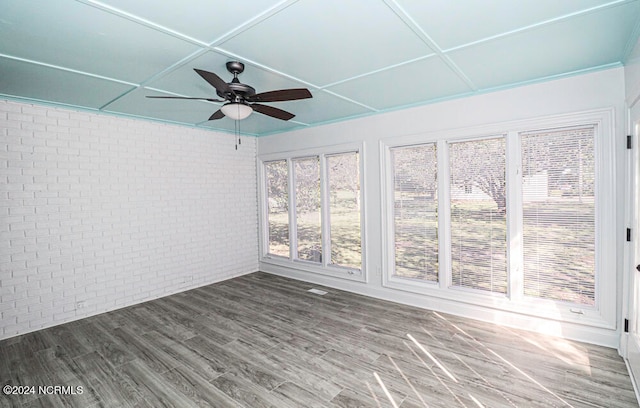 unfurnished sunroom featuring ceiling fan