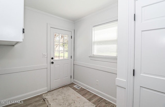 doorway with wood-type flooring and ornamental molding