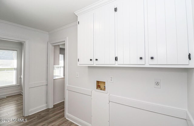 washroom with dark hardwood / wood-style floors, electric dryer hookup, washer hookup, cabinets, and ornamental molding