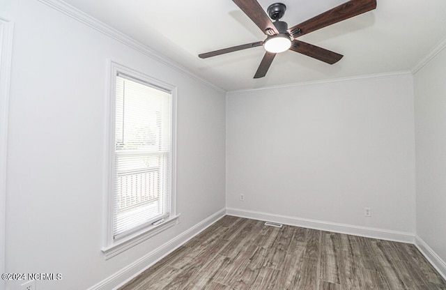 empty room with wood-type flooring, plenty of natural light, and crown molding