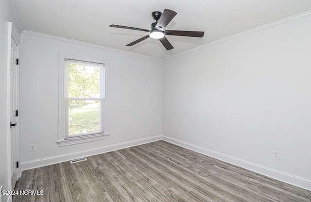 unfurnished room featuring wood-type flooring, ornamental molding, and ceiling fan