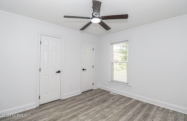 unfurnished bedroom with ceiling fan, light wood-type flooring, and ornamental molding