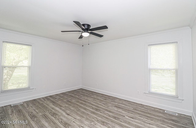 spare room with ornamental molding, hardwood / wood-style flooring, and ceiling fan