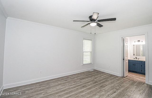 unfurnished bedroom with ensuite bathroom, crown molding, ceiling fan, and dark hardwood / wood-style flooring