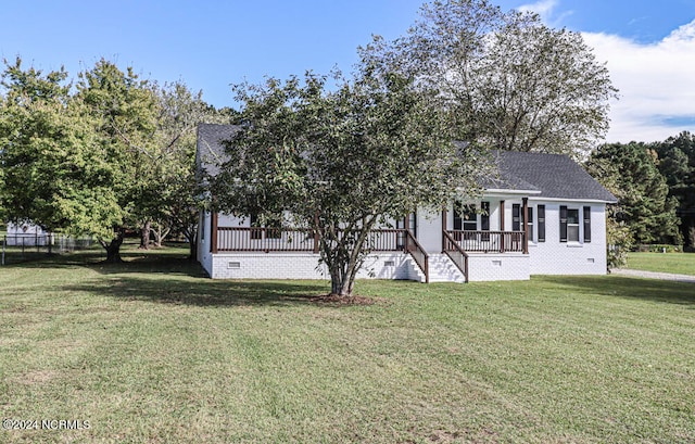 view of front of house featuring a front yard and a wooden deck