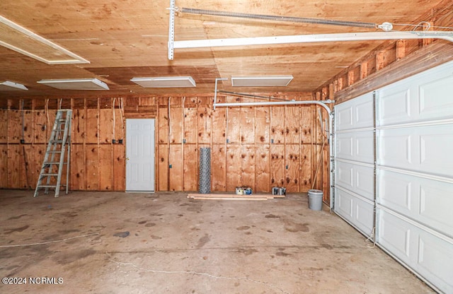 garage featuring wood walls