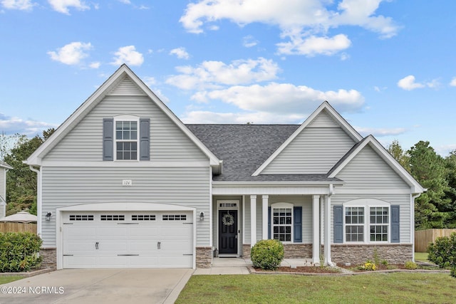 view of front of home featuring a front lawn and a garage