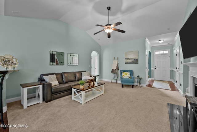 living room featuring lofted ceiling, ceiling fan, and light colored carpet