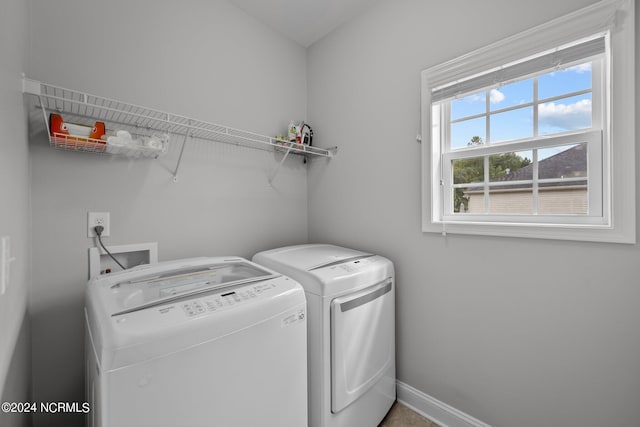 washroom with washing machine and clothes dryer