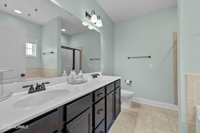 bathroom with tile patterned flooring, vanity, walk in shower, and toilet