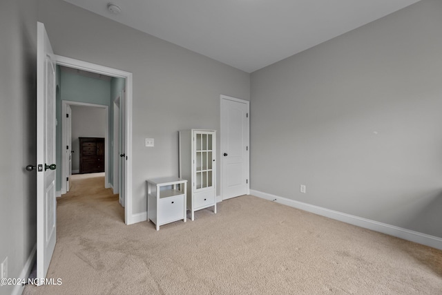 unfurnished bedroom featuring light colored carpet