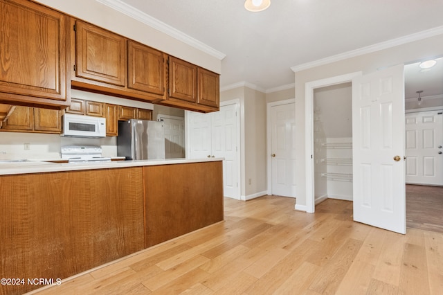 kitchen with ornamental molding, kitchen peninsula, light wood-type flooring, and white appliances