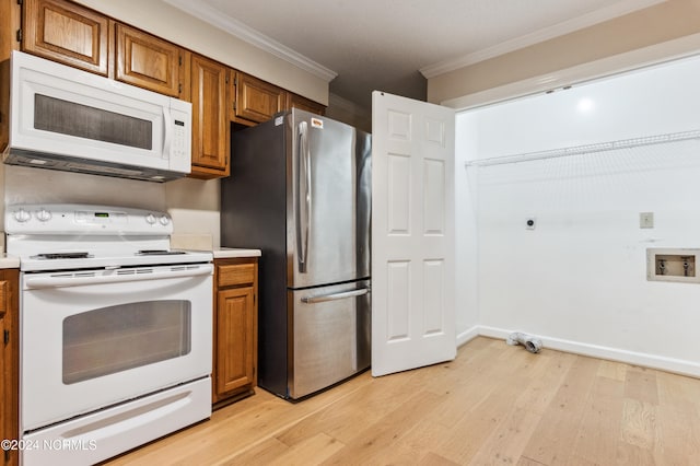 kitchen with white appliances, crown molding, and light wood-type flooring