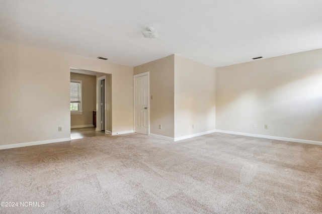 spare room with light carpet