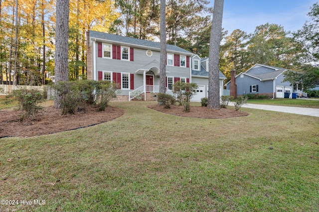 colonial-style house with a garage and a front lawn