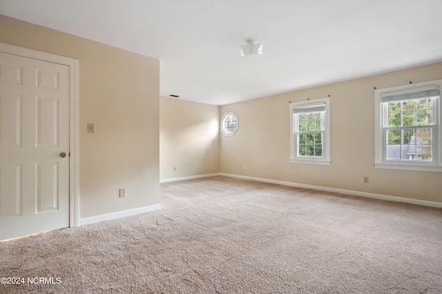 spare room with light colored carpet