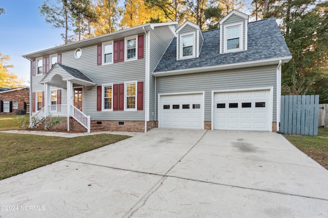 view of front facade featuring a porch, a front yard, and a garage