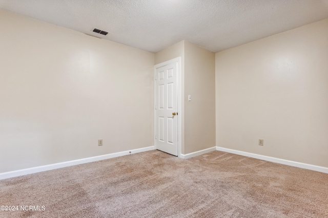 unfurnished room featuring a textured ceiling and carpet floors