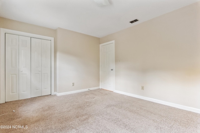 unfurnished bedroom with a closet and carpet floors