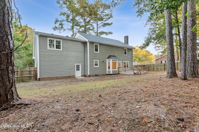 back of house featuring a wooden deck