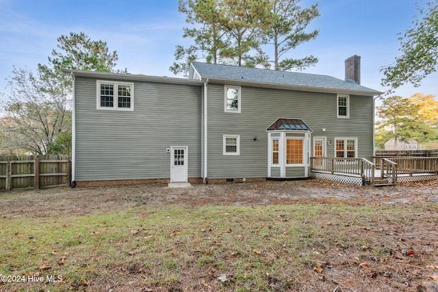 back of house featuring a wooden deck