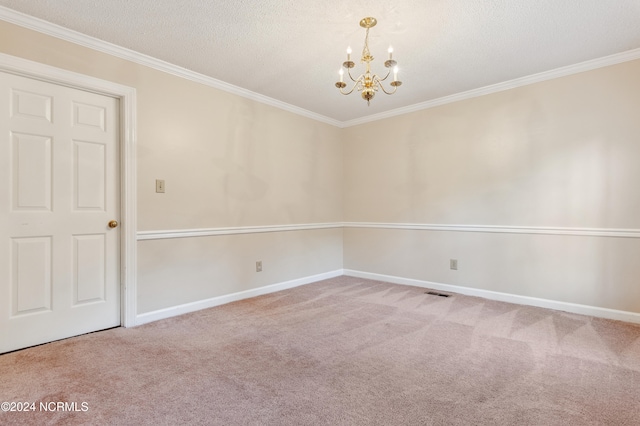 carpeted spare room with crown molding, a textured ceiling, and a notable chandelier