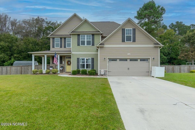 view of front of house featuring a garage, covered porch, and a front yard